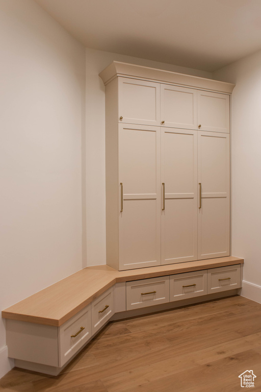 Mudroom featuring light wood-type flooring and baseboards