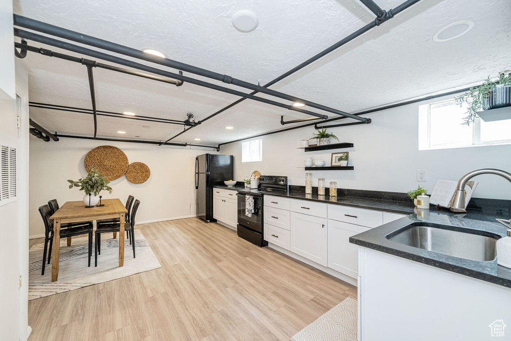 Kitchen with black appliances, open shelves, a sink, recessed lighting, and white cabinetry