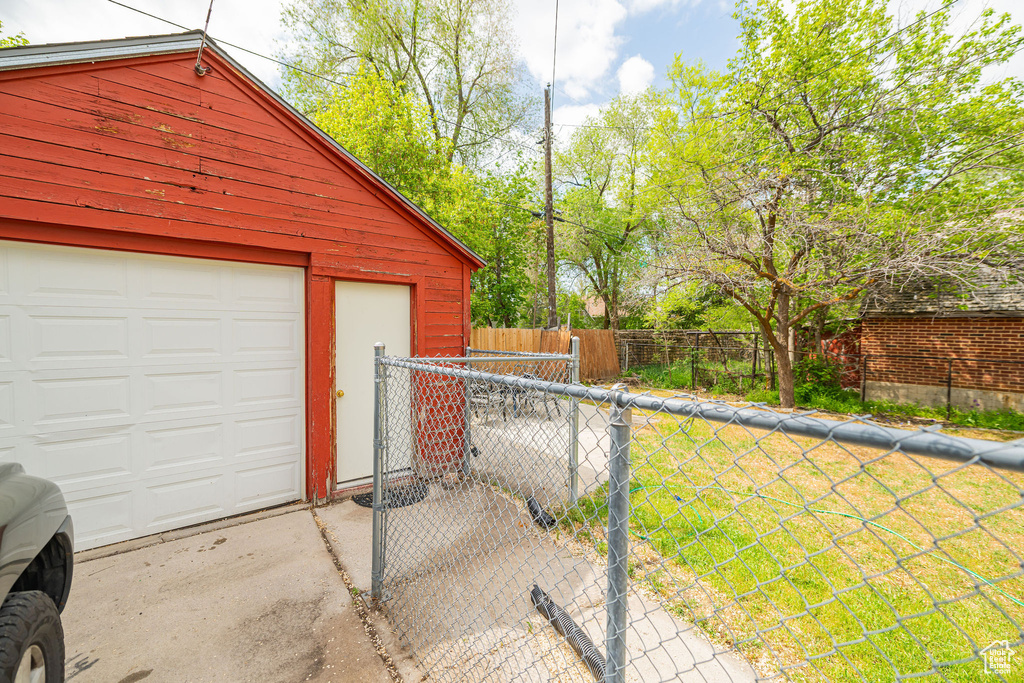 Garage featuring fence and driveway