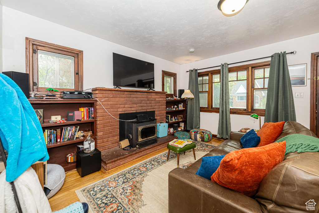 Living area with wood finished floors and a wood stove