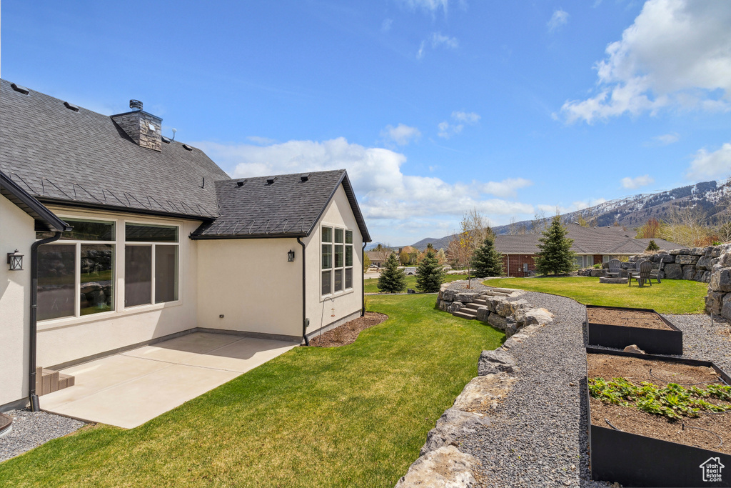 View of yard featuring a patio area and a mountain view
