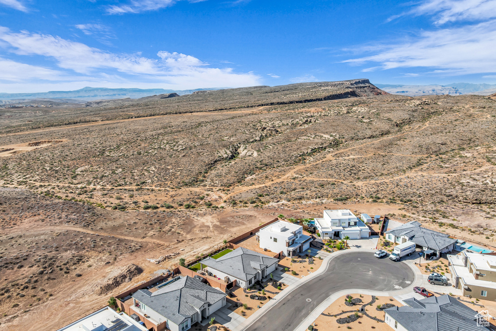 View of rural area with a desert landscape, a mountain backdrop, and nearby suburban area