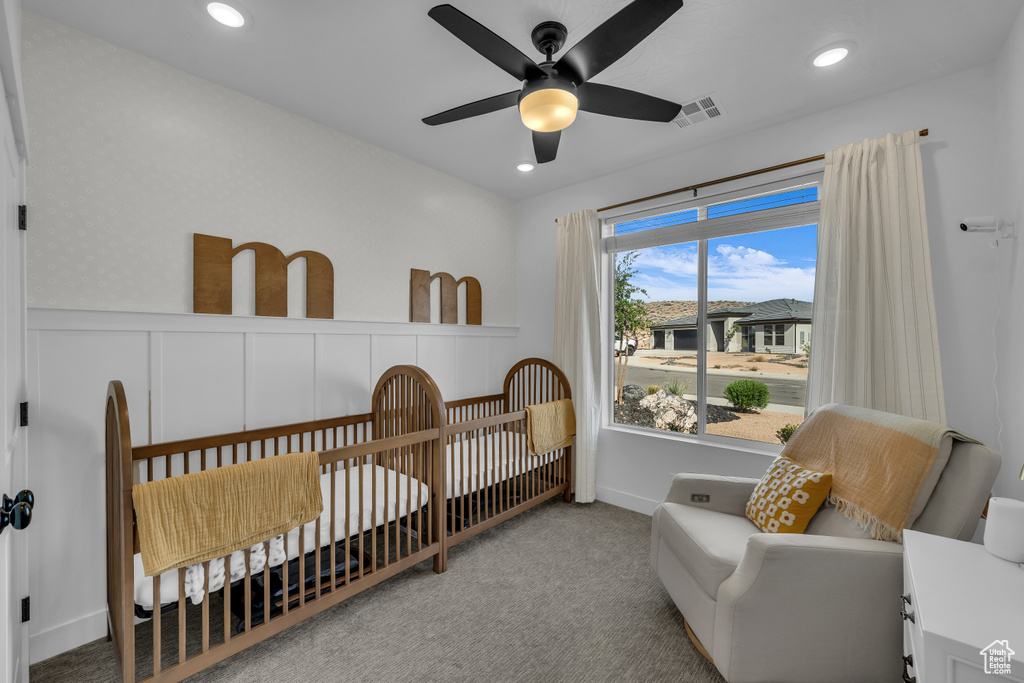 Carpeted bedroom featuring a nursery area, recessed lighting, and a ceiling fan