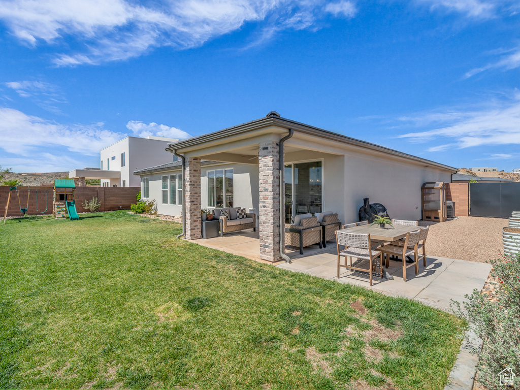 Back of house featuring an outdoor hangout area, stucco siding, a fenced backyard, and a patio