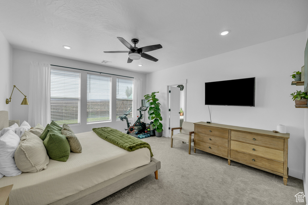Carpeted bedroom featuring recessed lighting and a ceiling fan