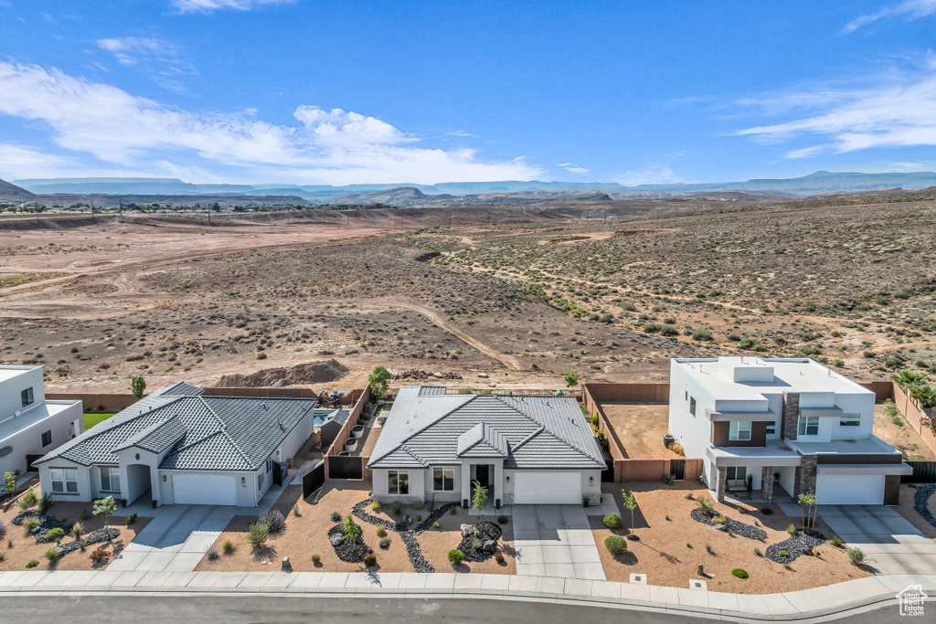 View of rural area featuring a mountain backdrop and a desert landscape