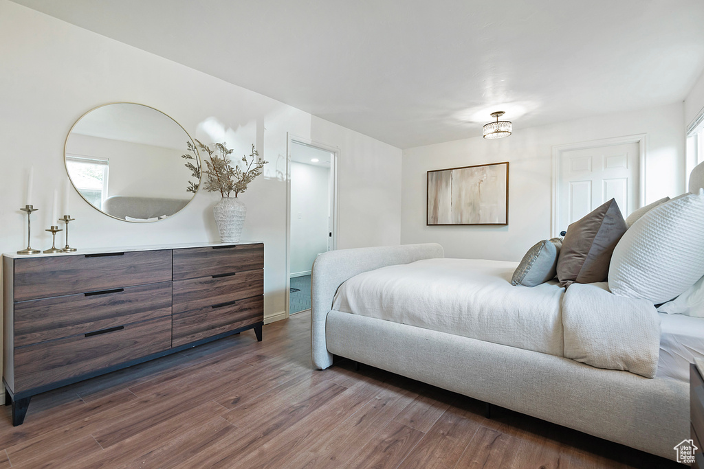 Bedroom with wood finished floors and baseboards