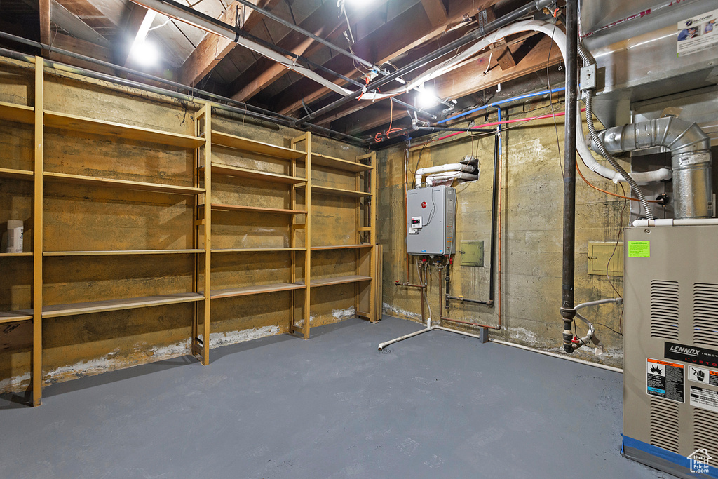 Unfinished basement featuring tankless water heater