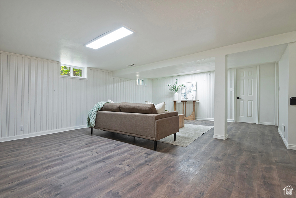 Living area featuring dark wood finished floors and baseboards