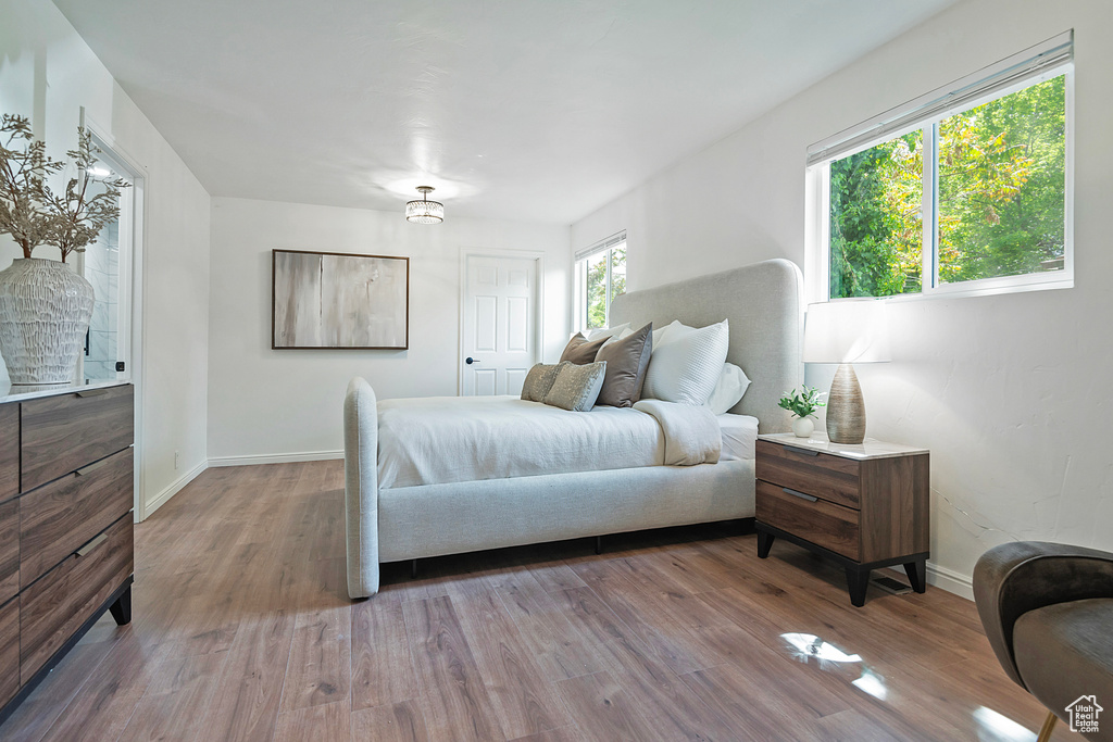 Bedroom with wood finished floors and baseboards