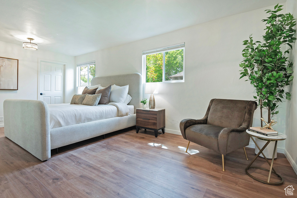 Bedroom with baseboards and wood finished floors