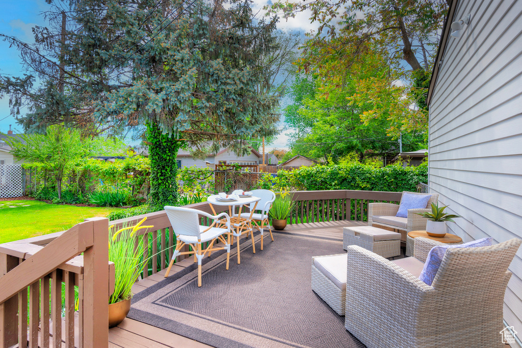 Wooden terrace featuring fence