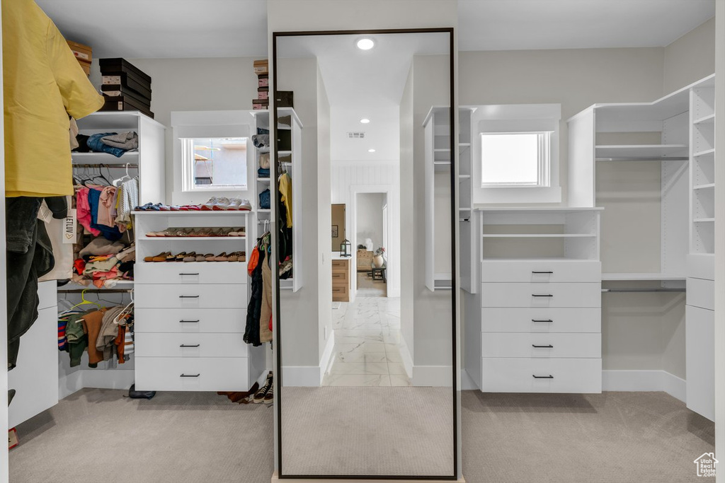 Spacious closet featuring marble look tiles