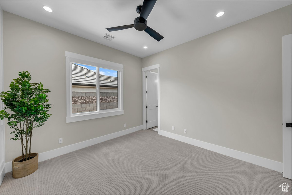 Spare room featuring a ceiling fan, light carpet, baseboards, and recessed lighting