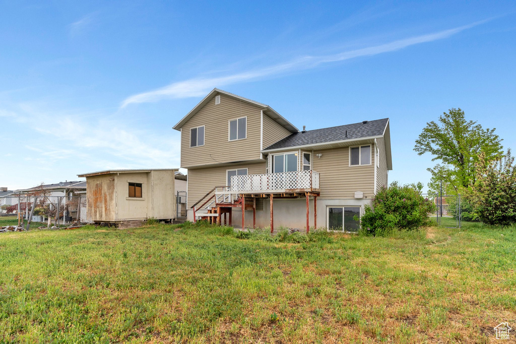 Rear view of property with a wooden deck and stairs