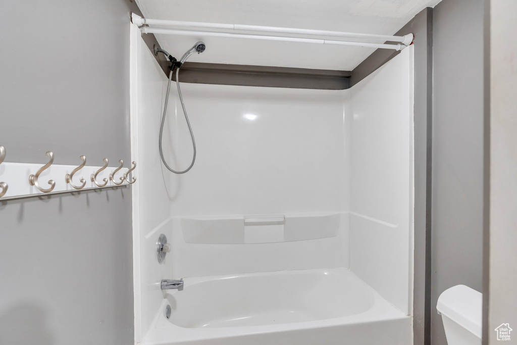 Full bathroom with toilet and bathtub / shower combination