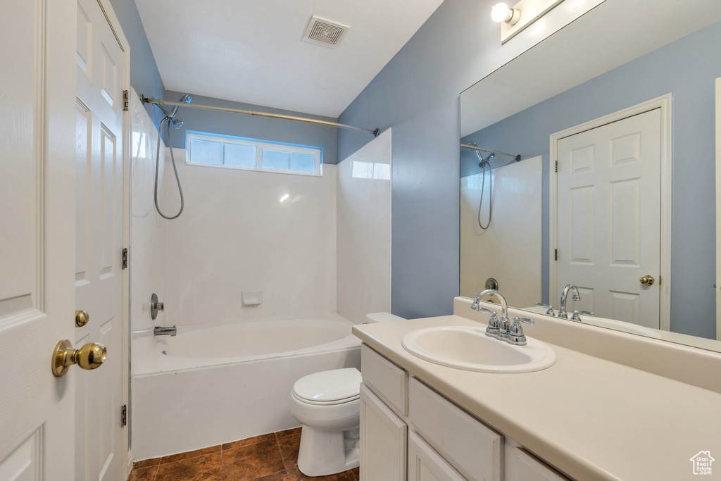 Bathroom with tub / shower combination, vanity, and toilet