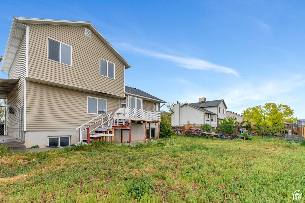Rear view of property with a wooden deck