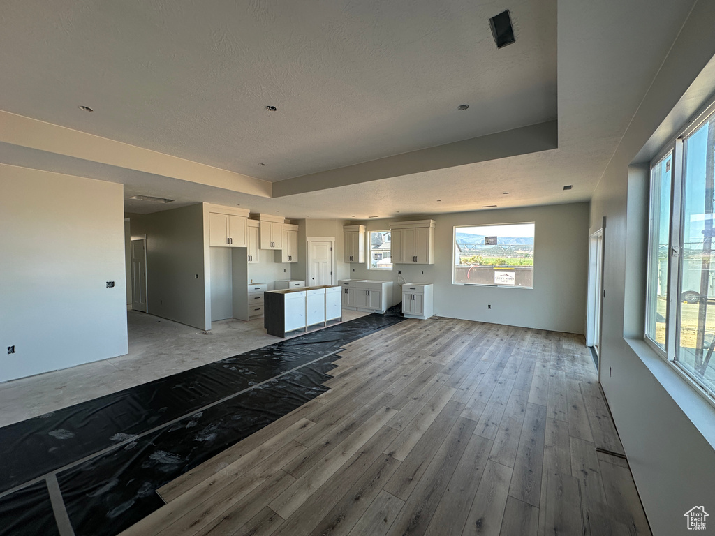 Unfurnished living room with light wood-style floors