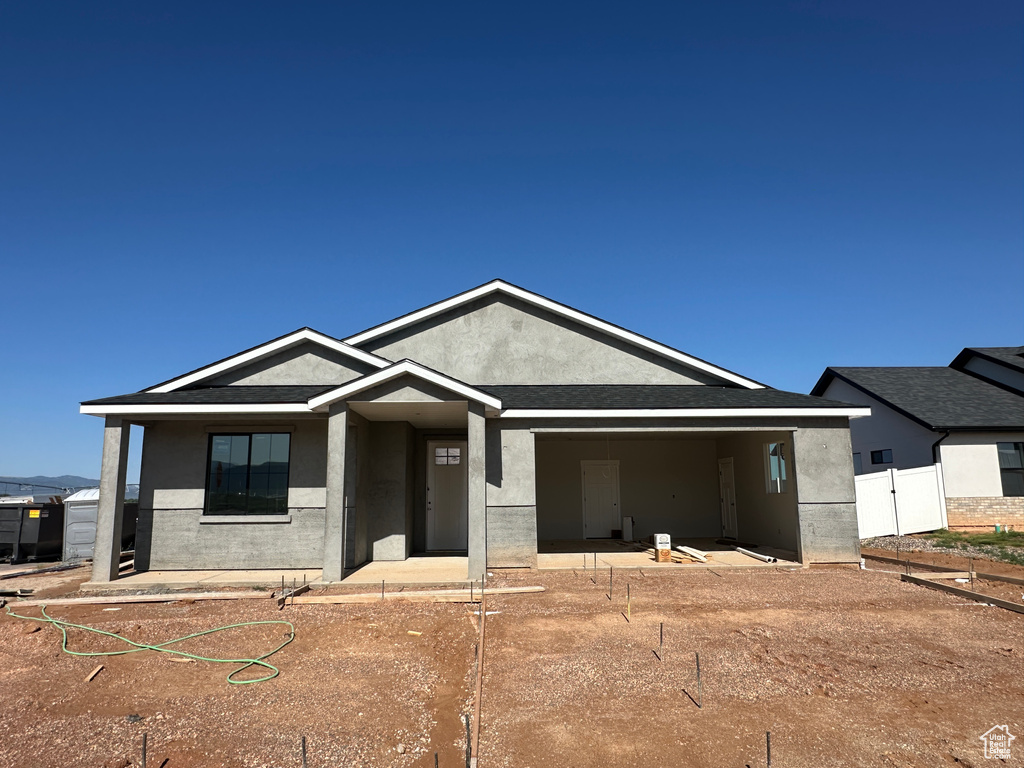 Ranch-style home featuring stucco siding