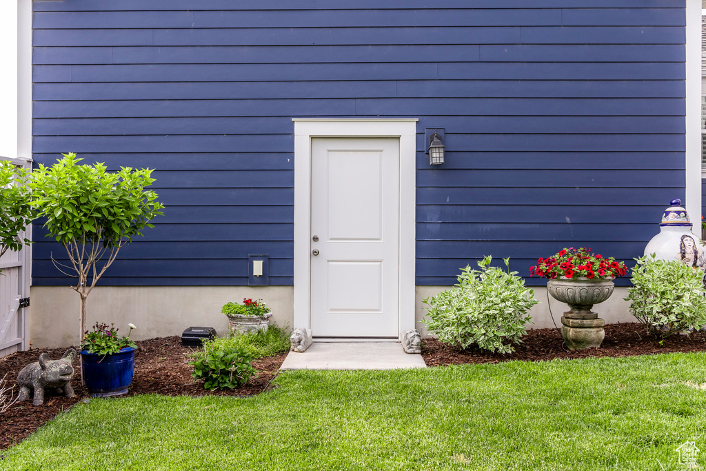 Doorway to property with a yard