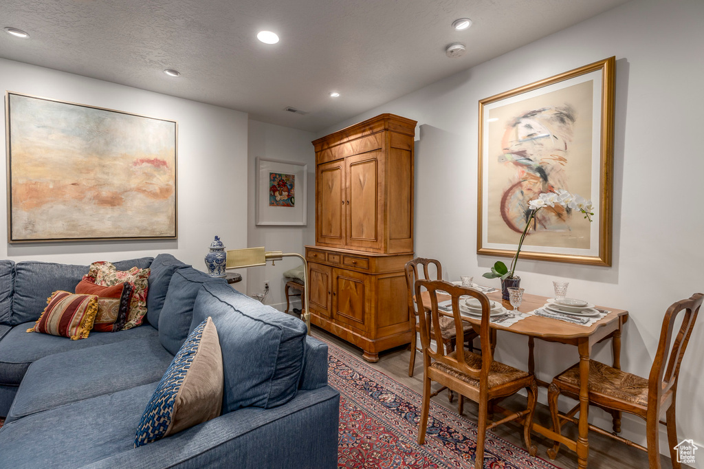 Living room with light wood-type flooring and recessed lighting