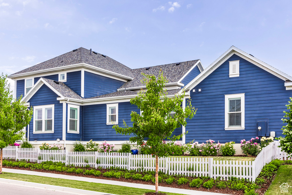 Traditional-style house with a fenced front yard