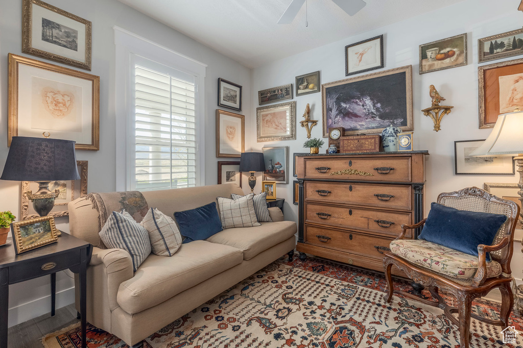 Living room featuring ceiling fan and wood finished floors