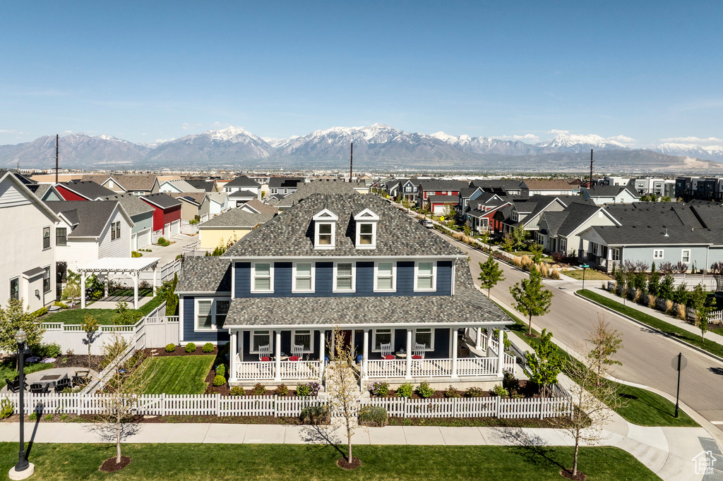 View of front facade featuring covered porch, a residential view, a mountain view, and a pergola