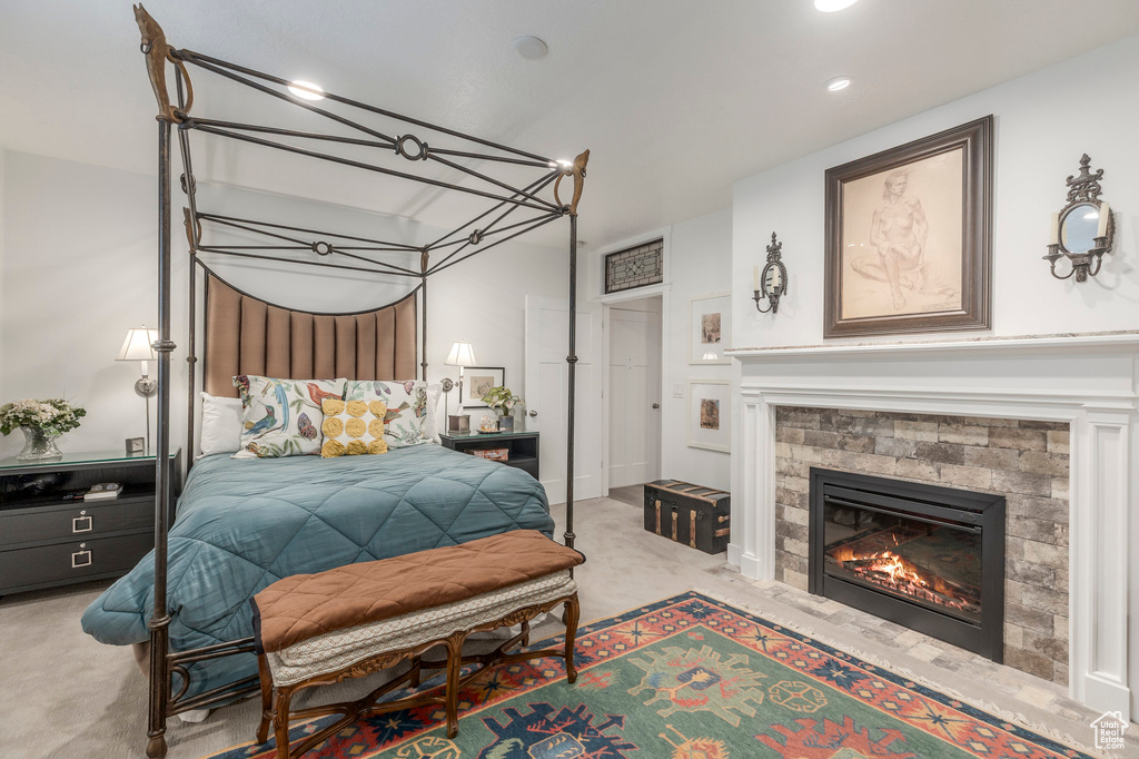 Bedroom with carpet flooring, a stone fireplace, and recessed lighting
