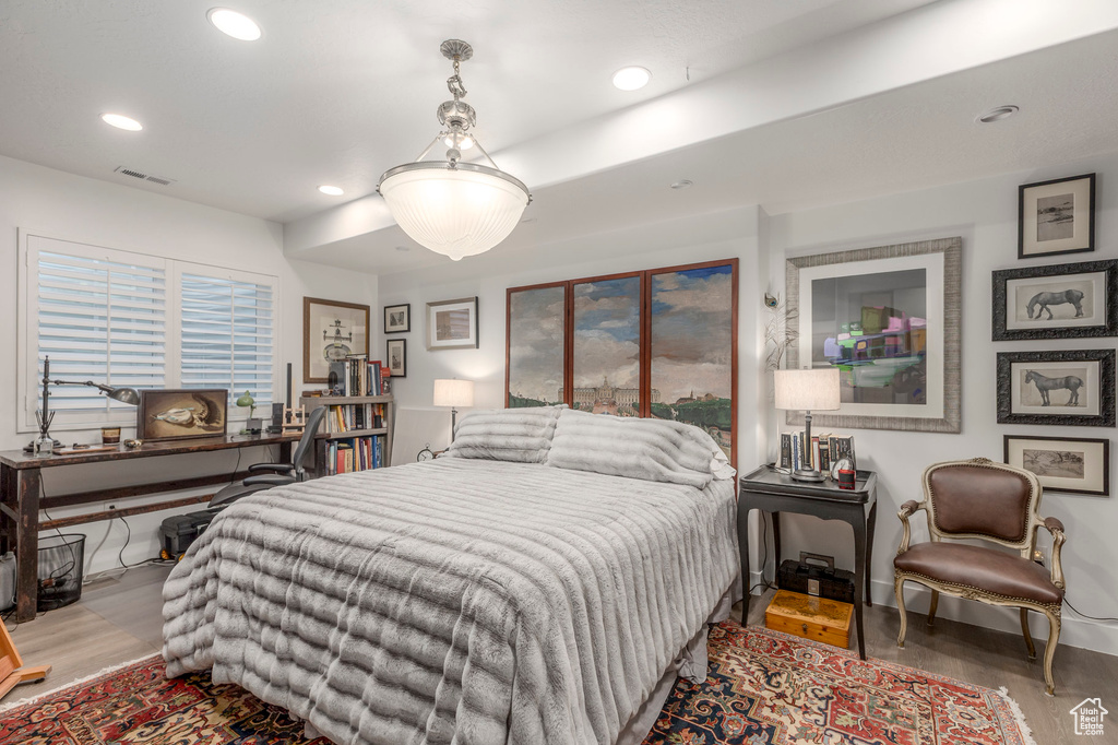 Bedroom featuring wood finished floors, recessed lighting, and baseboards
