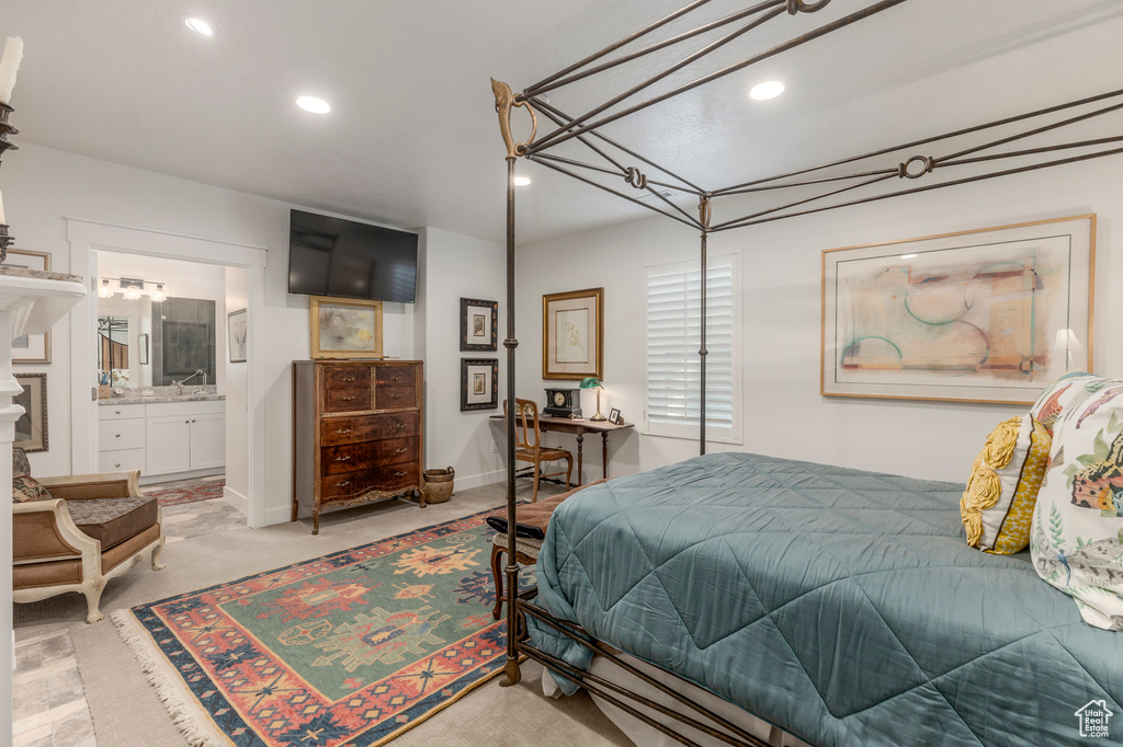 Bedroom with recessed lighting, light carpet, a sink, and connected bathroom