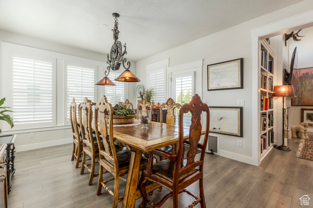 Dining space with baseboards and wood finished floors