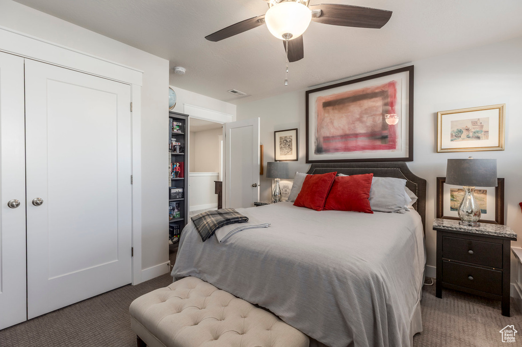 Bedroom with carpet floors, baseboards, ceiling fan, and a closet