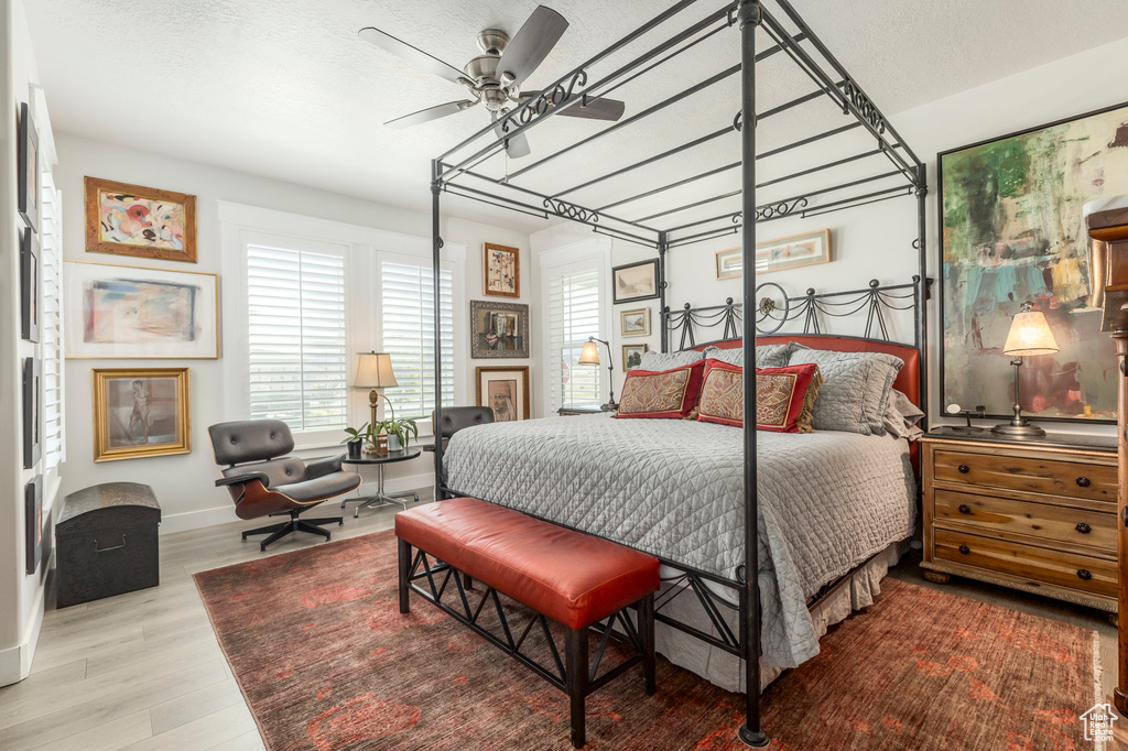 Bedroom with wood finished floors, baseboards, and ceiling fan