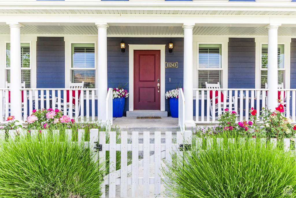 View of exterior entry featuring a porch
