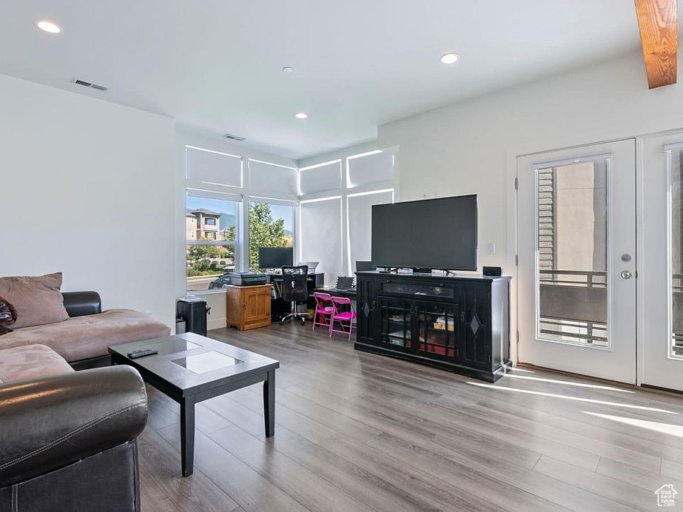 Living room featuring light wood finished floors and recessed lighting