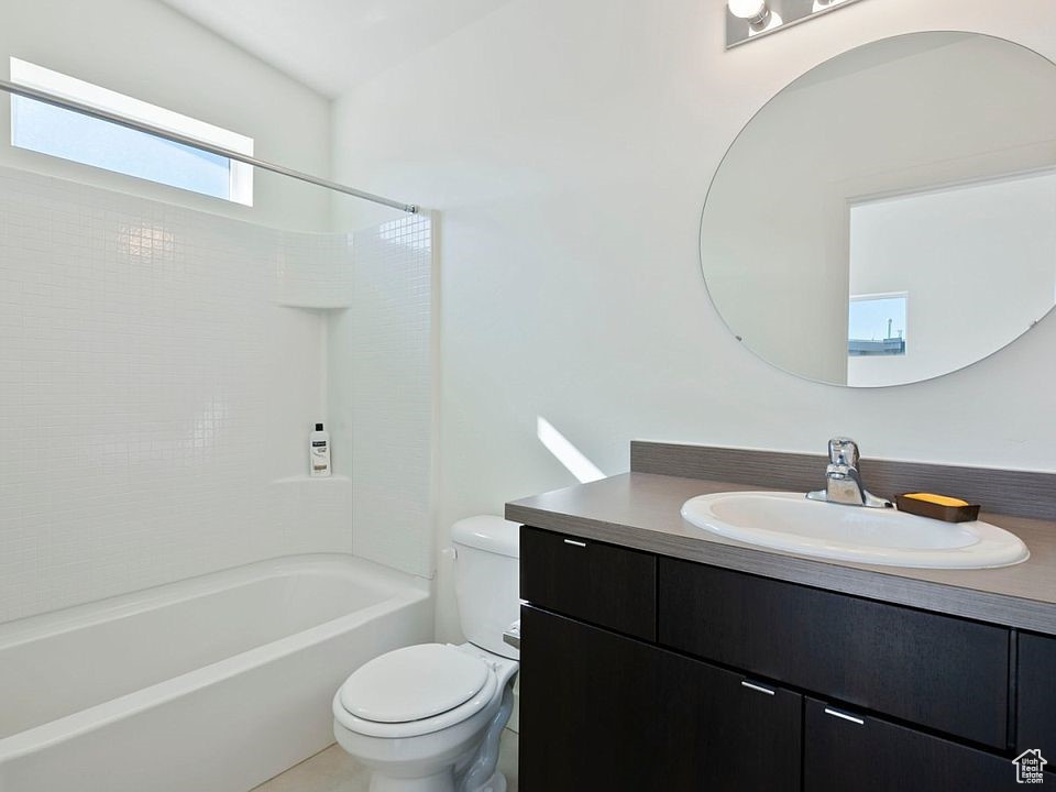 Full bath with toilet, vanity, and bathtub / shower combination