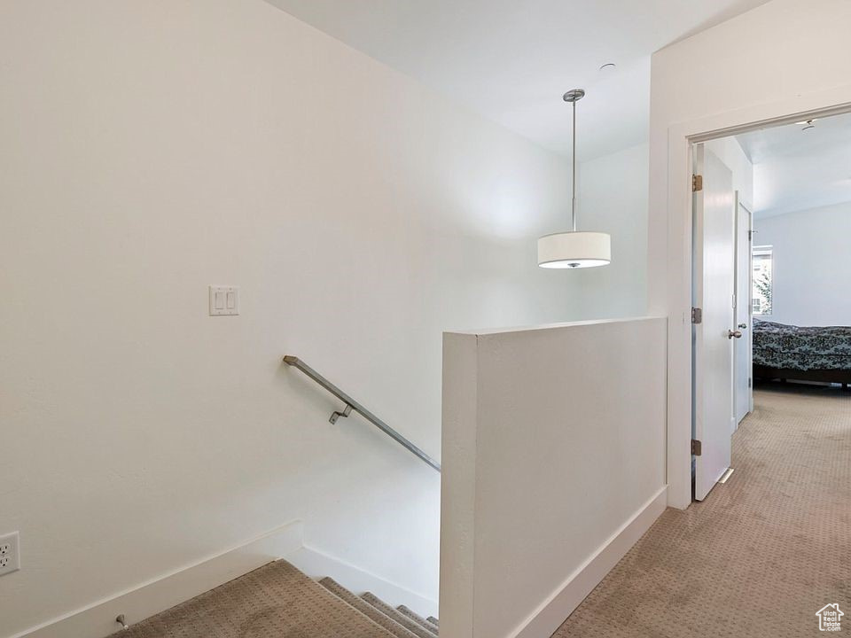 Stairs with carpet flooring and baseboards