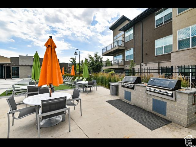 View of patio / terrace featuring a grill, outdoor dining space, and exterior kitchen