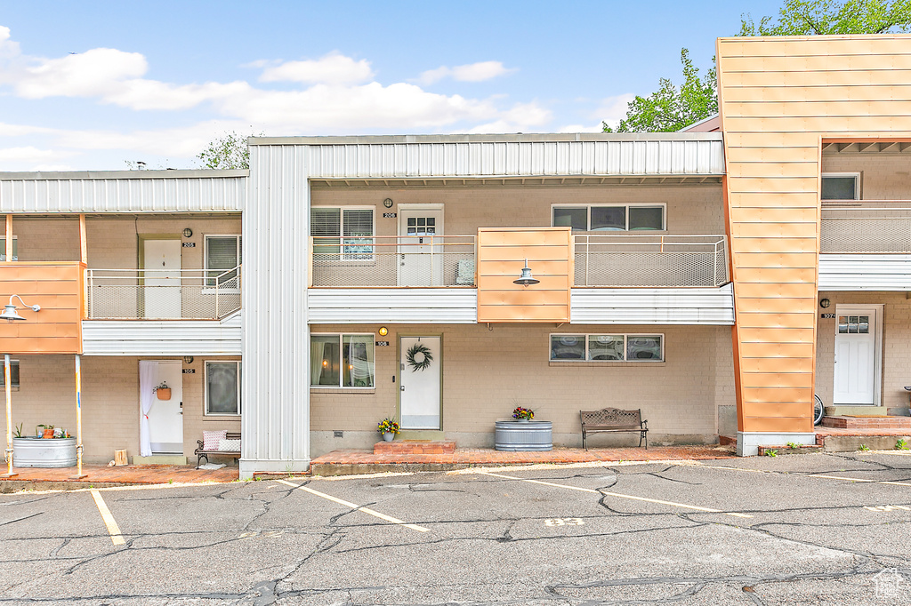 View of front of house with uncovered parking and crawl space