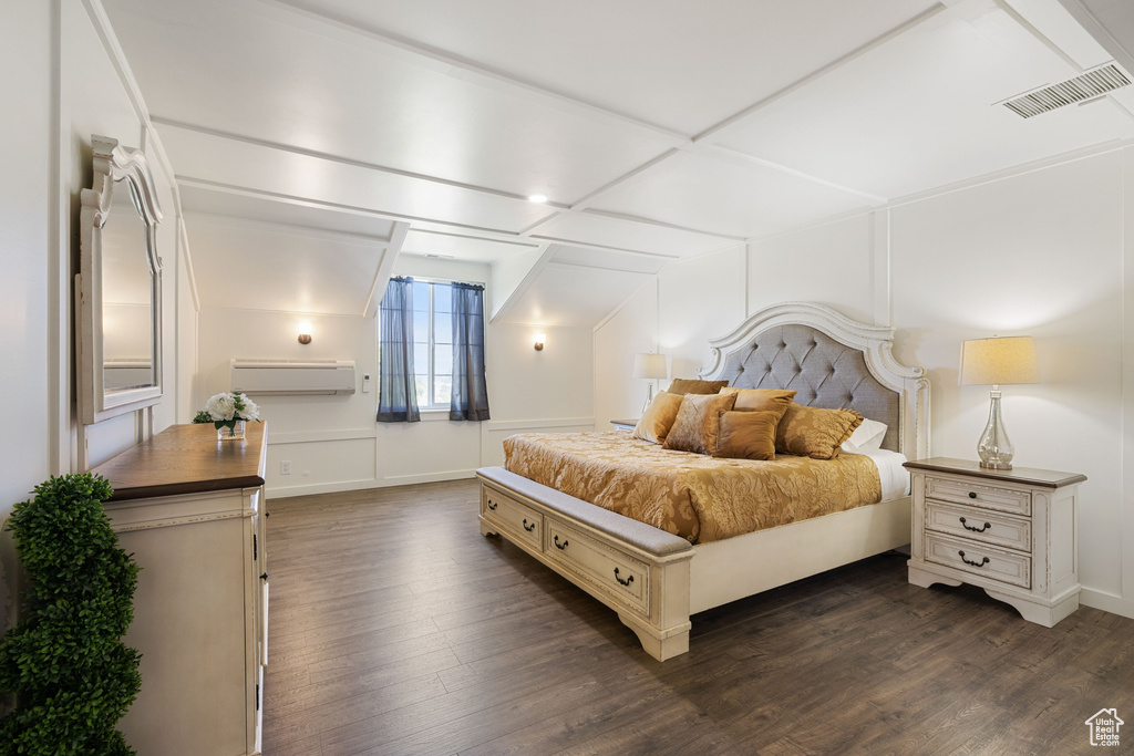Bedroom with dark wood finished floors, a wall mounted AC, lofted ceiling, and baseboards