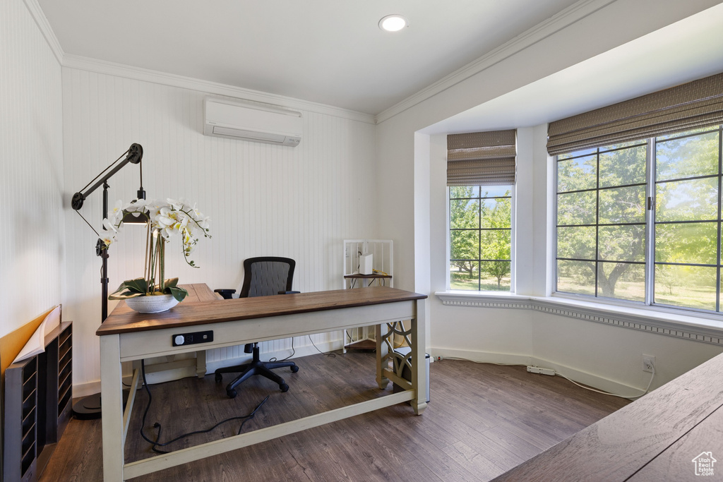 Office space featuring a wall mounted AC, ornamental molding, wood finished floors, and baseboards
