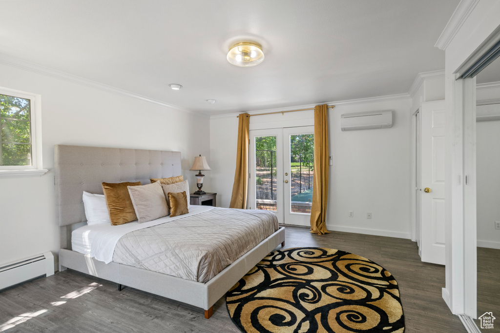 Bedroom featuring ornamental molding, wood finished floors, access to exterior, baseboard heating, and a wall mounted AC