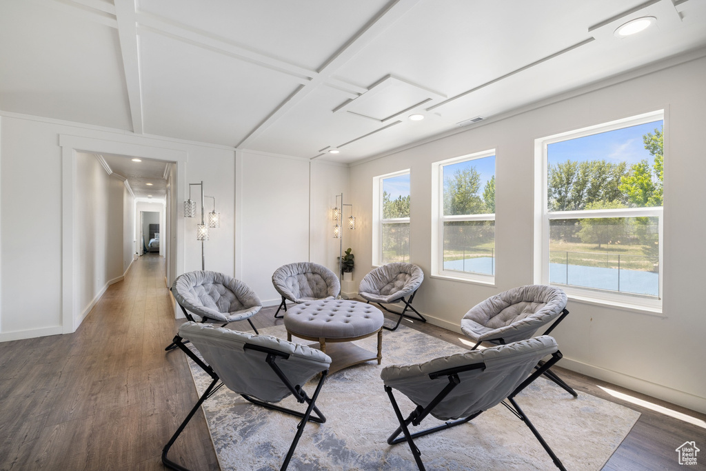 Living room with wood finished floors, baseboards, coffered ceiling, beamed ceiling, and recessed lighting
