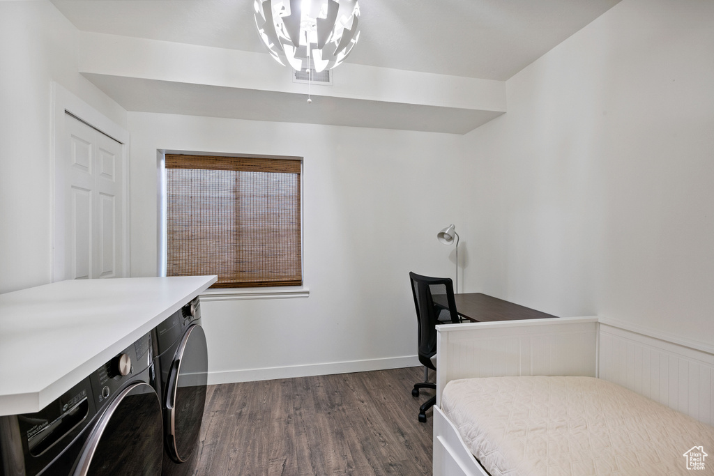 Bedroom with baseboards, dark wood-style floors, and washer and clothes dryer