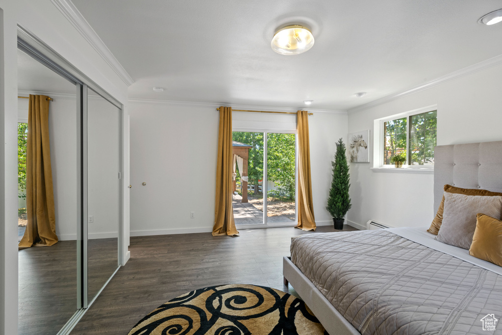 Bedroom featuring access to outside, ornamental molding, and wood finished floors