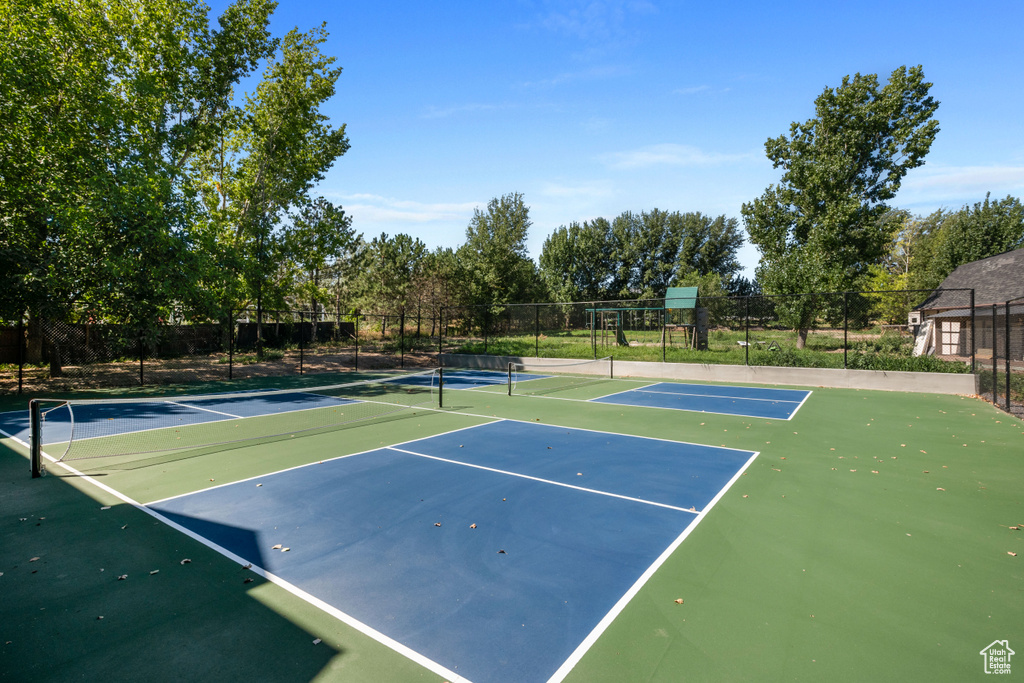 View of sport court featuring fence and community basketball court