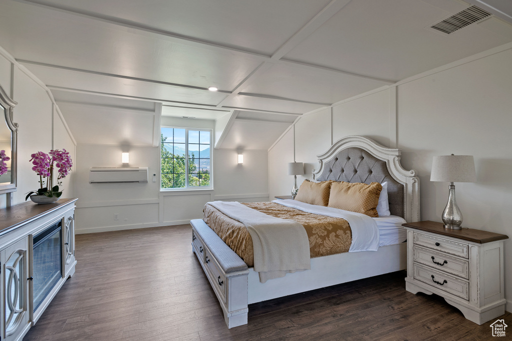 Bedroom with a wall mounted AC, lofted ceiling, dark wood finished floors, and visible vents