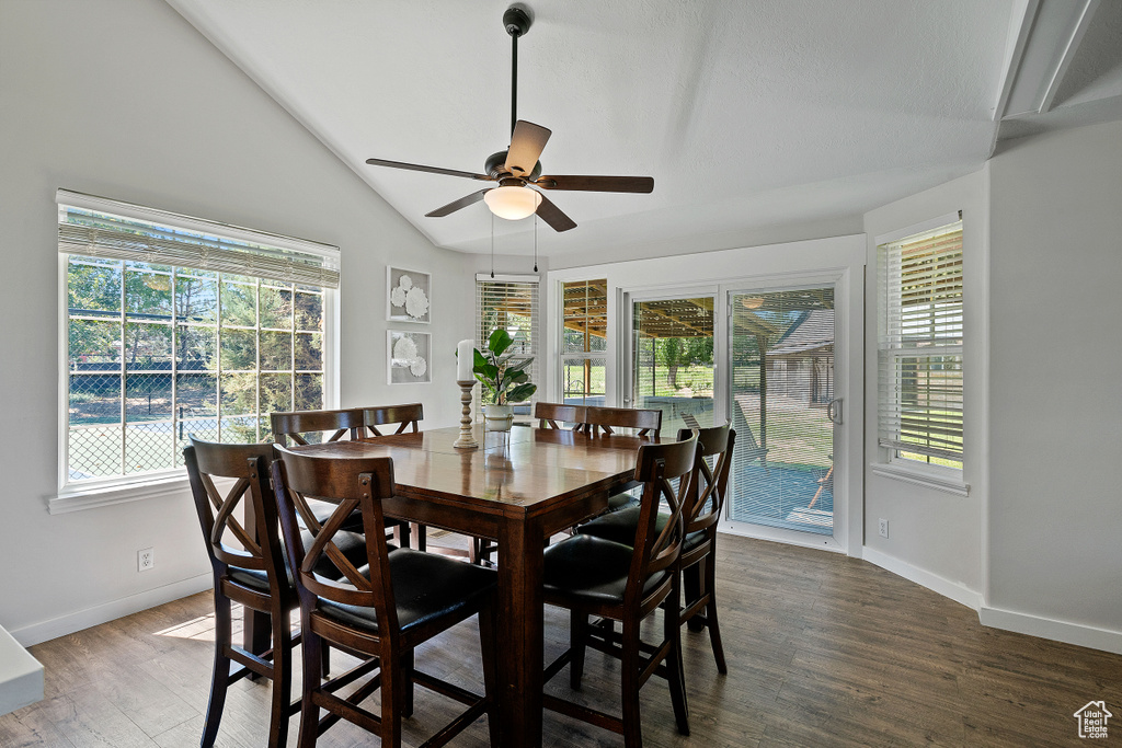 Dining area with baseboards, plenty of natural light, vaulted ceiling, and ceiling fan